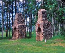 Detail view of the Rocky Mountain House chimneys showing archaeological remains of the four post sites, 2002.; Parks Canada Agency / Agence Parcs Canada, K. Dahlin, 2002.