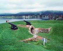 General view of the Black Hole Powder Magazine showing the mounded earth cover and the curved revetment walls of rubble stone, 1994.; Parks Canada Agency / Agence Parcs Canada, J.P. Jérôme, 1994.