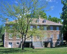 Front facade of the Carillon Barracks showing the British military design inspired by classical tradition, notably its rectangular two-storey massing on a raised basement and Palladian features, 2003.; Parks Canada Agency / Agence Parcs Canada, E. Le Bel, 2003.