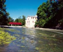 General view of the Légaré Mill, showing the viewscapes from the complex to the Rivière du Chêne, 1999.; Parks Canada Agency / Agence Parcs Canada, 1999.