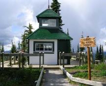 Vue de la façade du bâtiment, Ouest, qui montre l’extérieur revêtu de bardeaux de bois et de planches à clin, surmontée d’une coupole carrée, et percée de fenêtres.; Parks Canada Agency/Agence Parcs Canada , 2011
