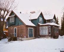 This view of the Wells Residence, from the southwest illustrates the asymmetrical influence of the Arts and Crafts style and the clinker brick cladding (March 2004).; City of Edmonton, 2004
