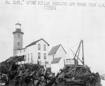 Historic photograph of the Pilier de Pierre Lighthouse showing the related buildings that used to surround the tower; Bibliothèque et Archives Canada | Library and Archives Canada, PA-164478