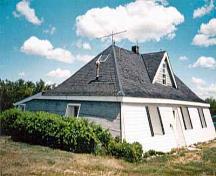 General view of the Addison Sod House, showing its low one-and-a-half-storey, pyramidal massing set under a hipped roof.; Parks Canada | Parcs Canada