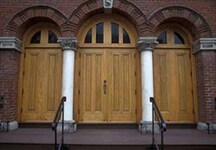 View of the entrance of the Congregation Emanu-el Temple, showing the triple entrance with twin ornamental columns, 1996.; Parks Canada Agency / Agence Parcs Canada, Barrett & MacKay, 1996.