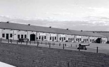 General view of the Commissariat Stores / Reverse Fire Chamber East, showing the long limestone ashlar shot-proof wallcut exterior stone wall, 1996.; Parks Canada | Parcs Canada, 1996.