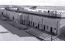 Exterior photo of the Curtain Wall and Demi-Bastions, showing Kingston limestone, ashlar stone walls with regular pattern loopholes, 1996.; Parks Canada | Parcs Canada, Graham 1996