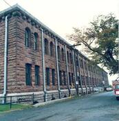 Corner view of a façade of the Halifax Drill Hall, 1990.; Department of National Defence/ Ministère de la Défence nationale, 1990.