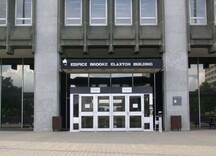 General view of the Brooke Claxton Building, showing the centrally placed main entrance surrounded by a studied mix of glass and black granite walls, 2004.; Public Works and Government Services Canada / Travaux publics et Services gouvernementaux Canada, 2004.